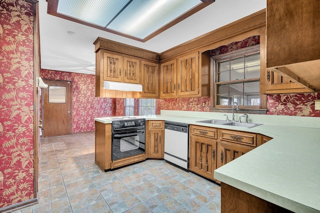 kitchen featuring black range with electric cooktop, dishwashing machine, sink, and kitchen peninsula