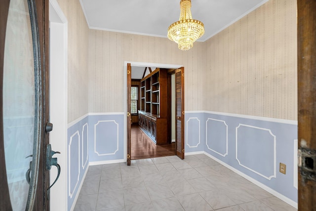 interior space with crown molding, an inviting chandelier, and light tile patterned floors