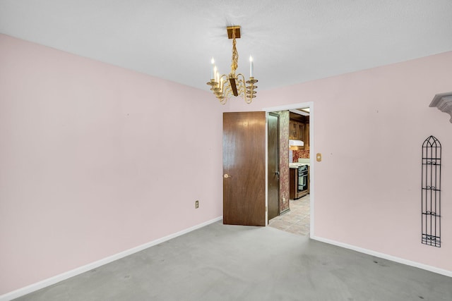 unfurnished room featuring an inviting chandelier