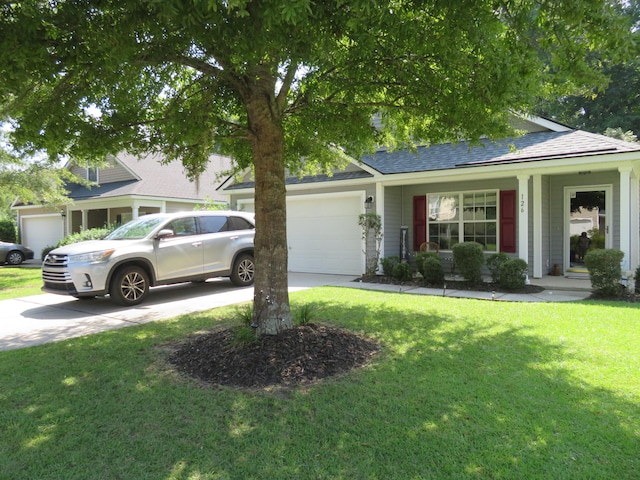 view of front of property with a garage and a front lawn