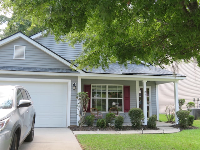 ranch-style home featuring covered porch, a garage, and central AC unit