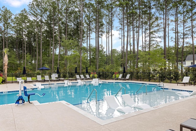 view of swimming pool featuring a patio area