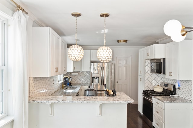 kitchen featuring a peninsula, decorative backsplash, stainless steel appliances, and a sink