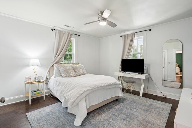 bedroom with wood-type flooring, ornamental molding, multiple windows, and visible vents