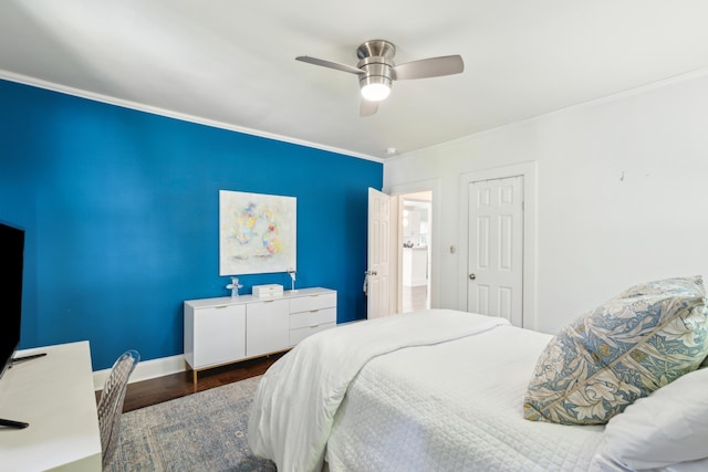 bedroom with baseboards, wood finished floors, a closet, ceiling fan, and ornamental molding