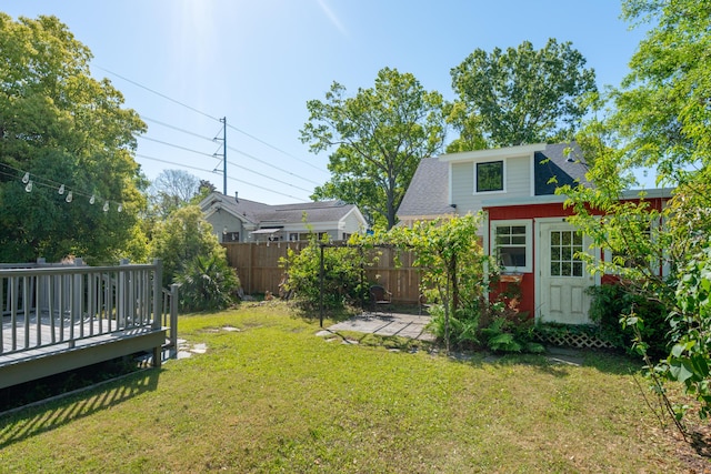 view of yard with fence, a patio, and a deck