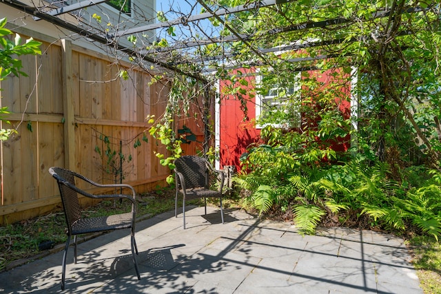view of patio featuring fence