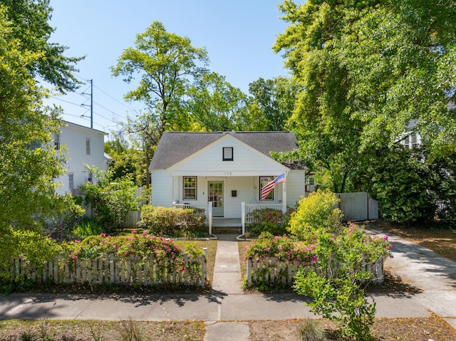 bungalow-style home featuring fence and covered porch