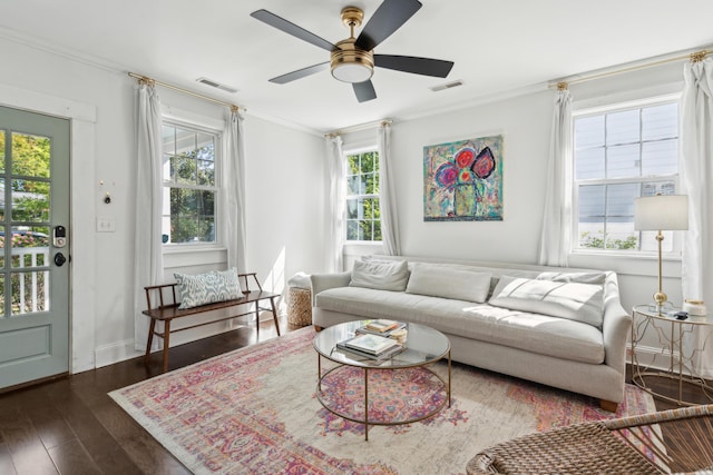 living area with wood finished floors, visible vents, and plenty of natural light