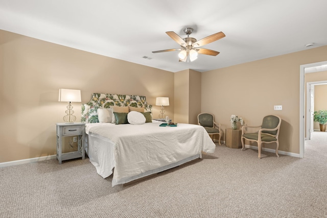 carpeted bedroom with a ceiling fan, visible vents, and baseboards