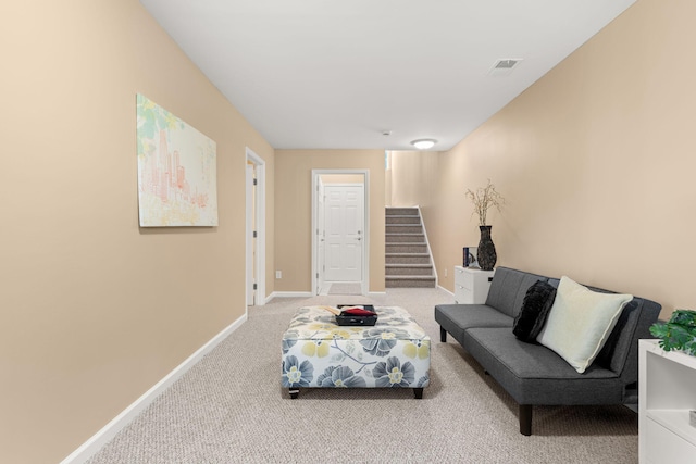 living area with stairs, carpet, visible vents, and baseboards