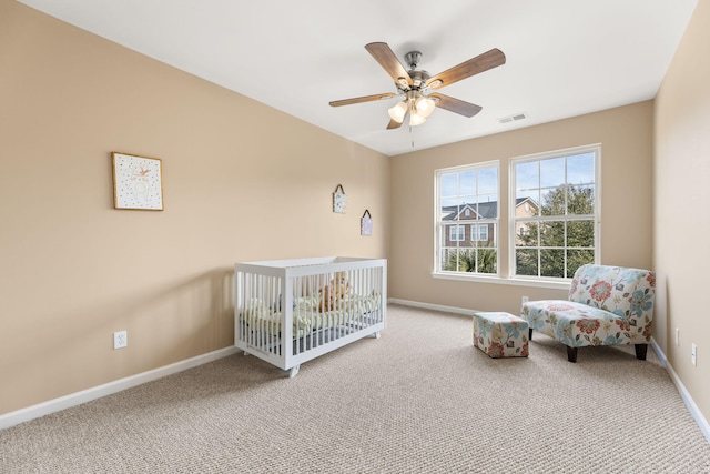 carpeted bedroom featuring baseboards, visible vents, and a ceiling fan