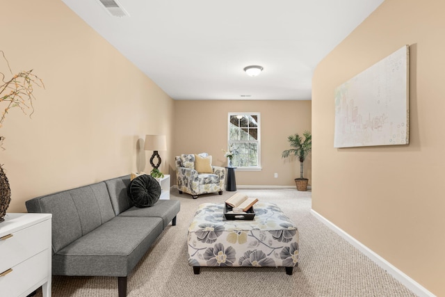 carpeted living room with visible vents and baseboards