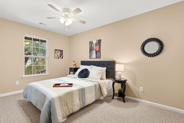 bedroom with baseboards, visible vents, ceiling fan, and carpet flooring