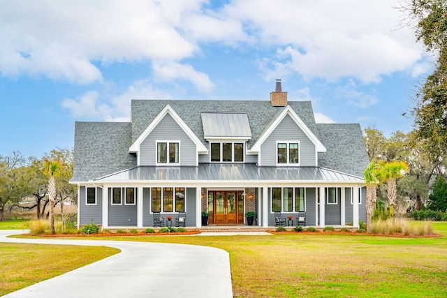 modern farmhouse with a front lawn and covered porch