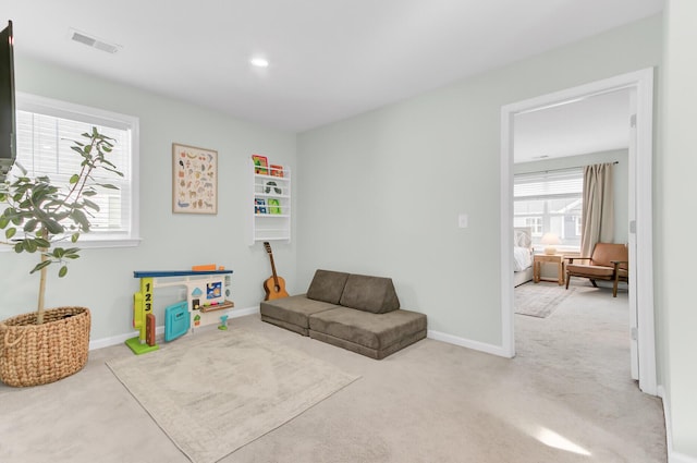 sitting room with visible vents, baseboards, and carpet floors