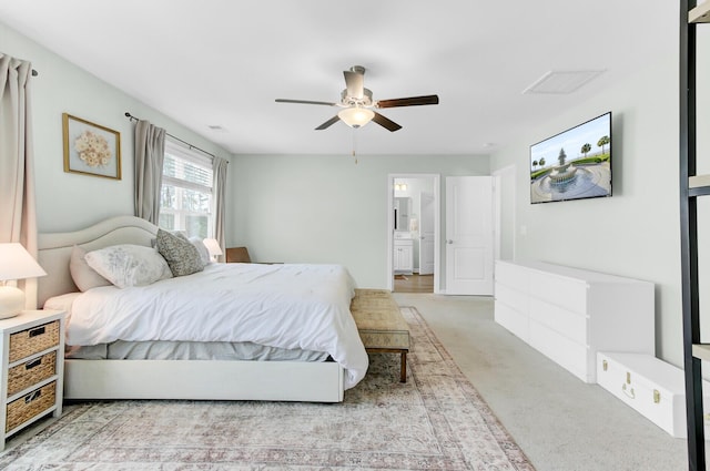 carpeted bedroom with a ceiling fan and visible vents