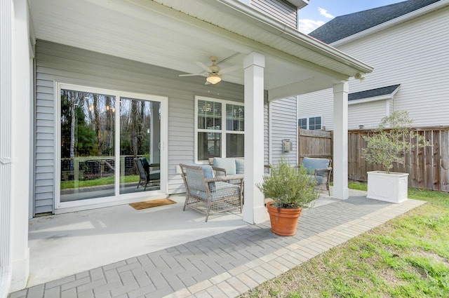 view of patio / terrace featuring ceiling fan and fence