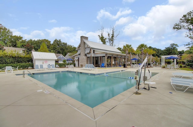 community pool featuring a patio and an outdoor structure