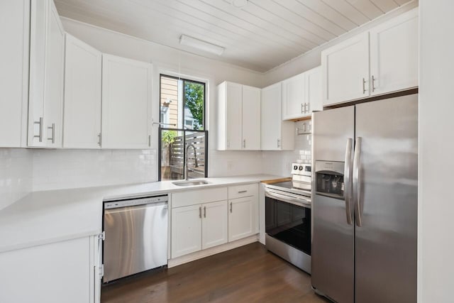 kitchen featuring a sink, appliances with stainless steel finishes, white cabinets, and light countertops