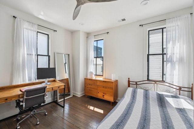 bedroom with baseboards, a ceiling fan, dark wood finished floors, and visible vents