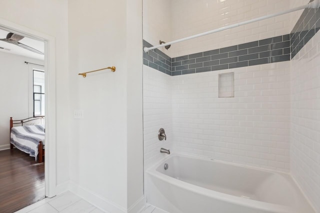 bathroom featuring connected bathroom, ceiling fan, tile patterned flooring, bathtub / shower combination, and baseboards
