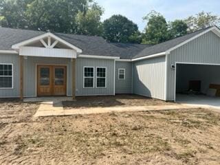 rear view of property with a garage