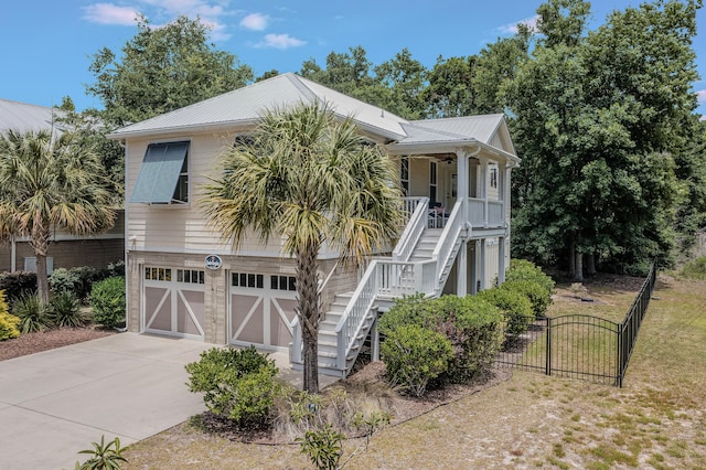 coastal home with a porch and a garage