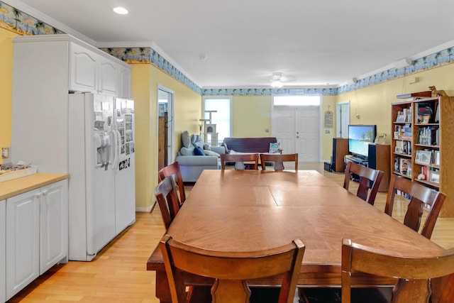 dining room featuring a ceiling fan, light wood-style floors, and ornamental molding