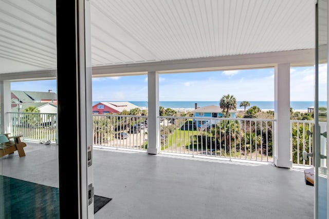 view of patio with a balcony and a water view