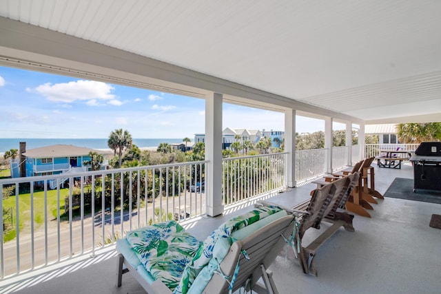 exterior space featuring grilling area and a water view