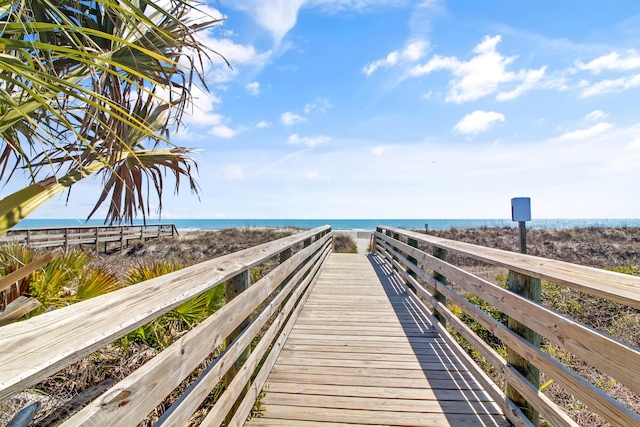 view of home's community featuring a water view and a view of the beach