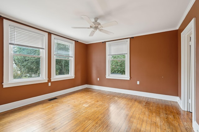 spare room featuring ornamental molding, ceiling fan, and light wood-type flooring