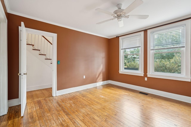 empty room featuring crown molding, ceiling fan, and light hardwood / wood-style floors