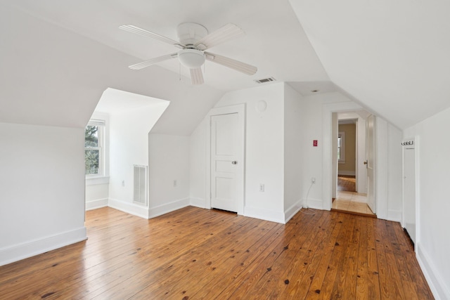 bonus room featuring hardwood / wood-style flooring, ceiling fan, and lofted ceiling