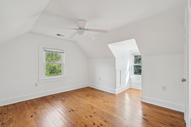 additional living space with lofted ceiling, hardwood / wood-style flooring, and ceiling fan