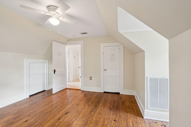 additional living space featuring dark hardwood / wood-style flooring, lofted ceiling, and ceiling fan