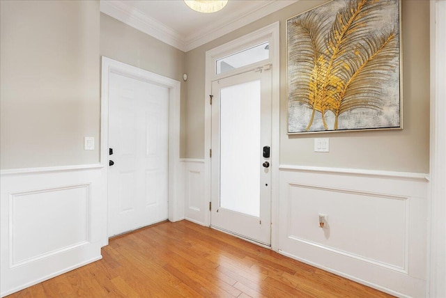 entrance foyer with crown molding and light hardwood / wood-style floors