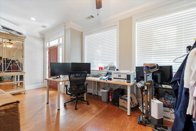 office space featuring hardwood / wood-style floors, ornamental molding, and a healthy amount of sunlight