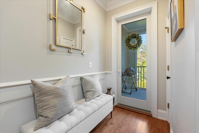 doorway featuring wood-type flooring and crown molding