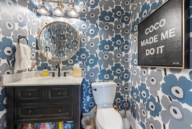 bathroom featuring vanity and toilet