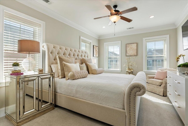 carpeted bedroom featuring crown molding and ceiling fan