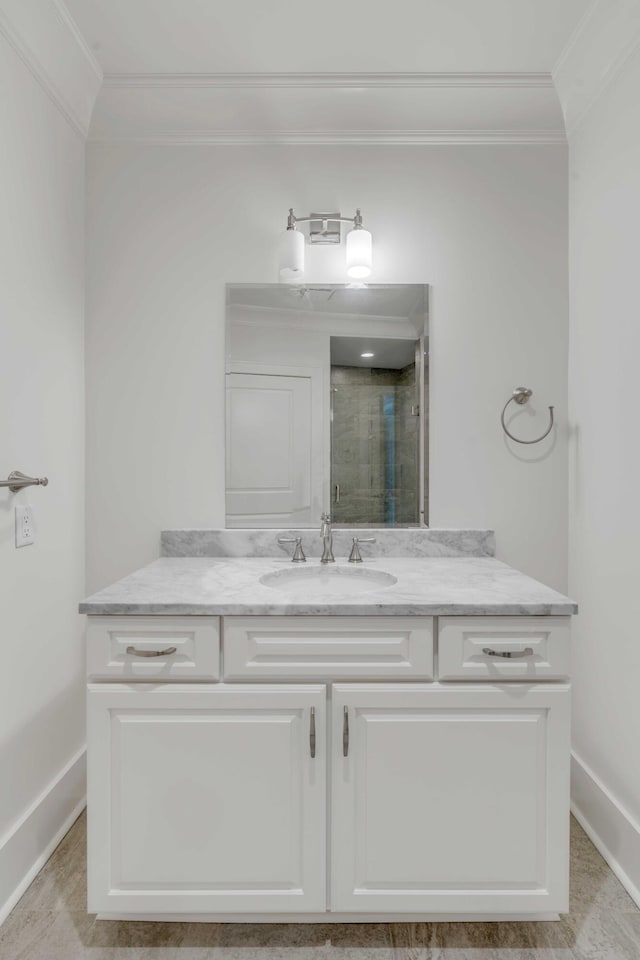 bathroom featuring a shower stall, vanity, and ornamental molding