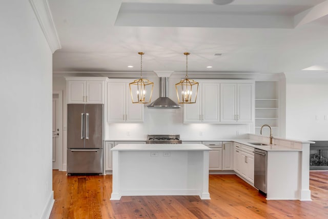 kitchen with a sink, light countertops, wall chimney exhaust hood, and stainless steel appliances