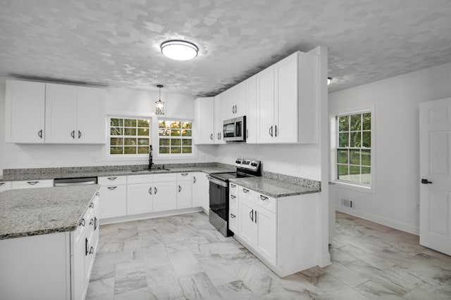 kitchen featuring light stone countertops, marble finish floor, appliances with stainless steel finishes, and a sink