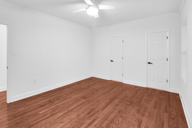 spare room with crown molding, baseboards, ceiling fan, and wood finished floors