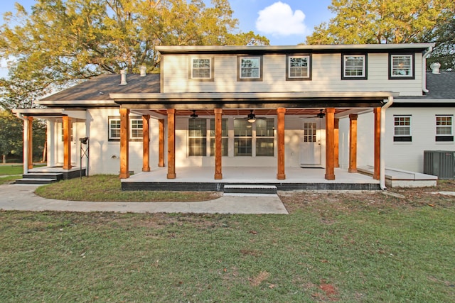 back of property featuring cooling unit, a lawn, a patio, and ceiling fan