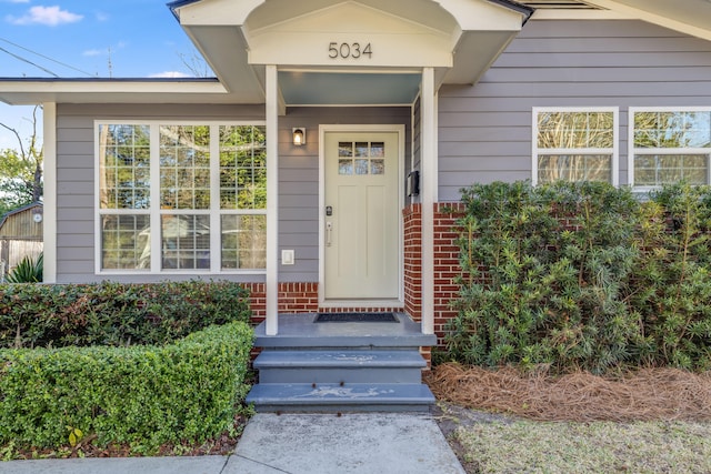 property entrance with brick siding