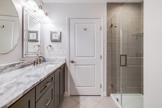 full bathroom with a stall shower, tile patterned flooring, and vanity