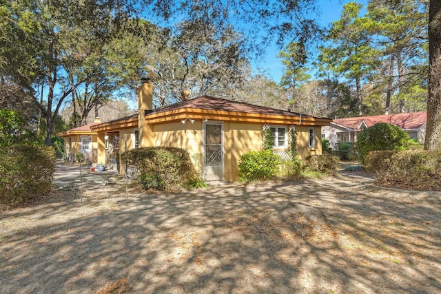 view of front of house featuring a chimney